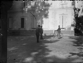 1 vue  - Trois hommes dont l\'un tenant son vélo devant un immeuble. / [Anonyme] (ouvre la visionneuse)